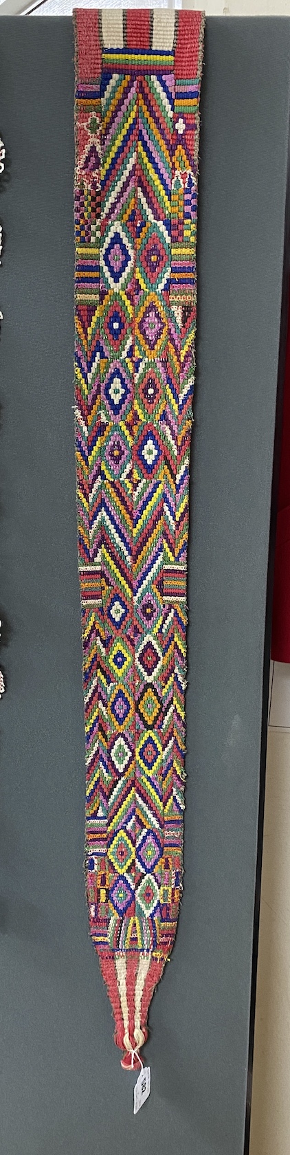 A 20th century Northern Indian multicoloured narrow woven wall hanging, 292cm long, 12cm wide